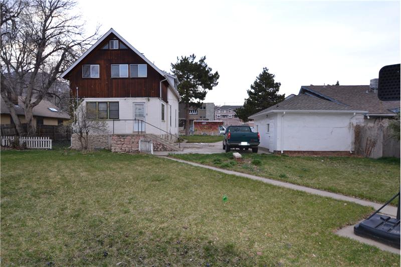Backyard showing back of house and garage