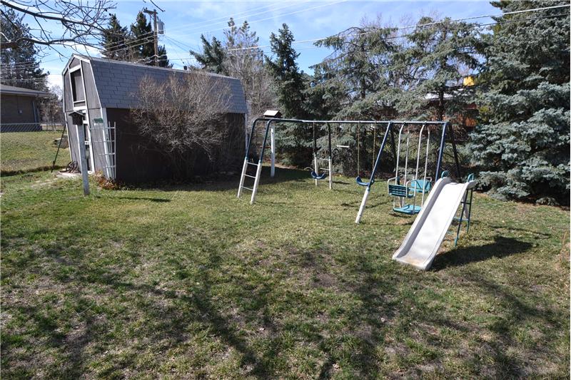 Backyard with play structure & barn
