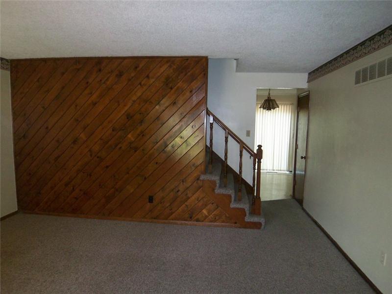 View of the Stairs and Into Kitchen