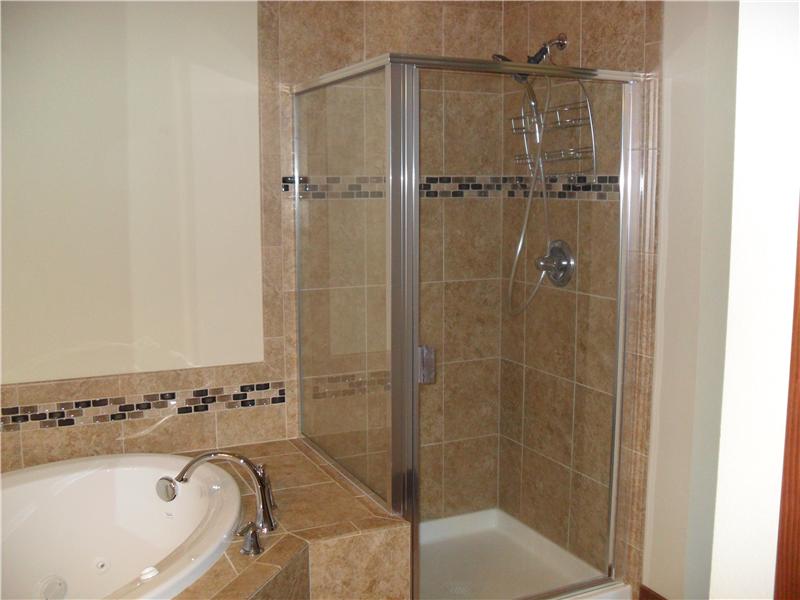 Shower next to jetted tub in master