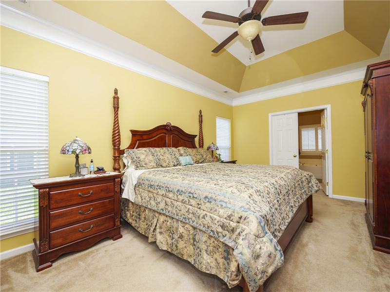 Tray ceiling with paddle fan and molding in master bedroom