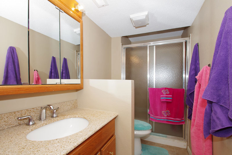 Basement bath with tile flooring and granite countertop