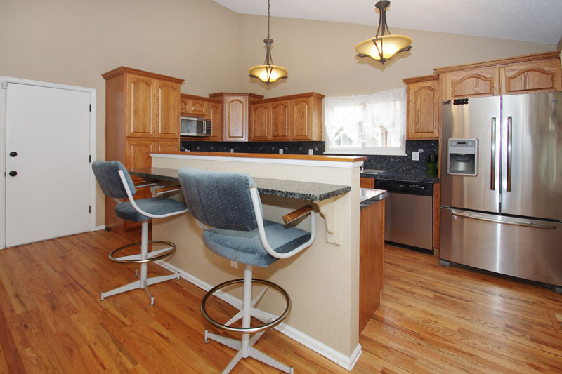 Breakfast bar, stainless appliances, and smooth top range.  