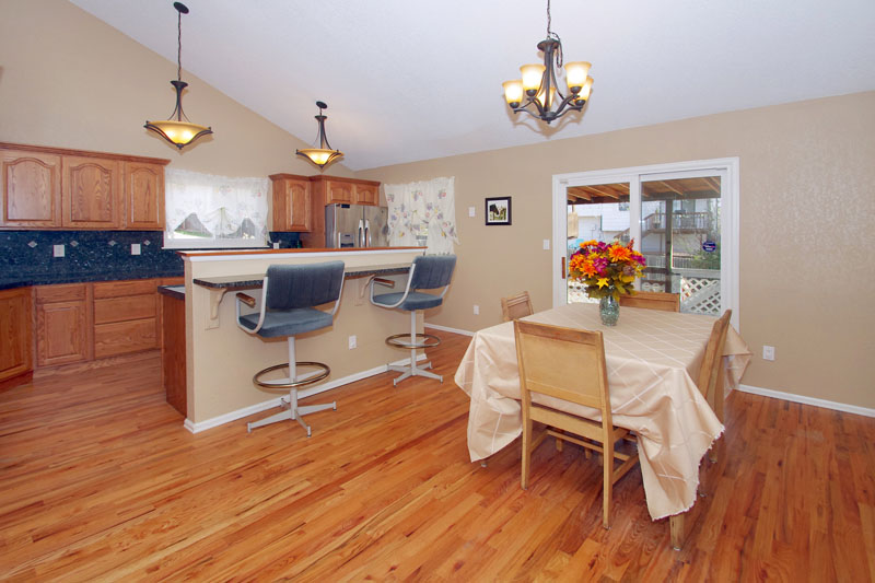 Spacious kitchen with hardwood flooring and vaulted ceilings.
