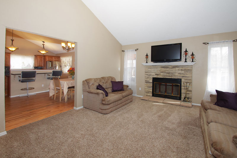 Vaulted and beamed ceiling in living room.