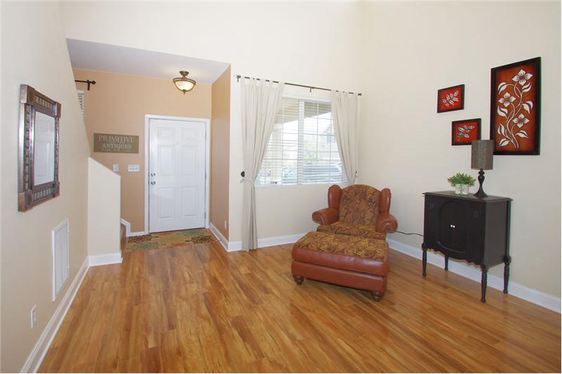 Bright living room with beautiful flooring and vaulted ceilings