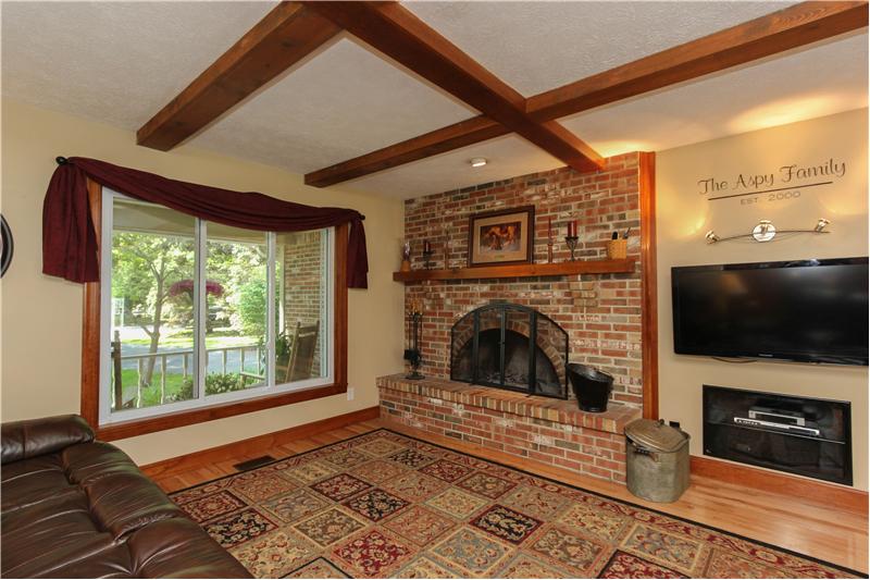 Family room with wood burning fireplace.