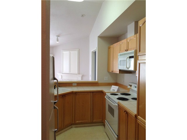 Kitchen is spacious with plenty of storage and counter space.