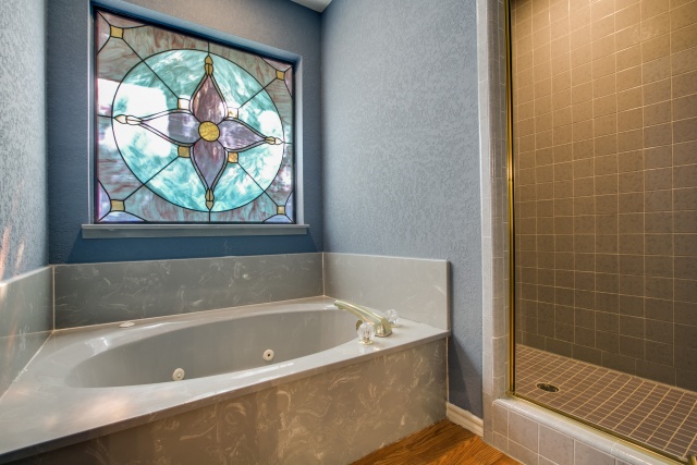 A jetted tub and separate shower are pictured here.