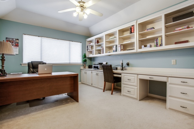 The office has plenty of storage space and built-ins.