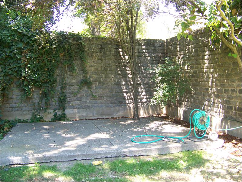 Rear Patio with Cobblestone Wall