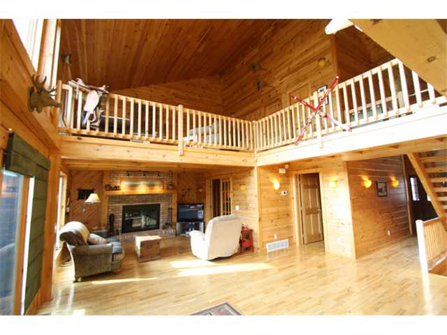 Great Room:  Sun-filled rooms, soaring ceilings, beautiful custom built log home