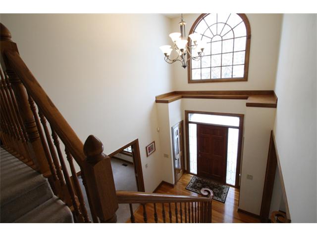 Entry/Foyer:  Soaring two story sun-filled foyer with gleaming hardwood floors, leaded glass side lights, 2 large coat closets
