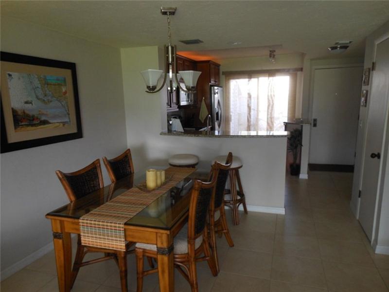 Dining area looking at front entrance and kitchen area