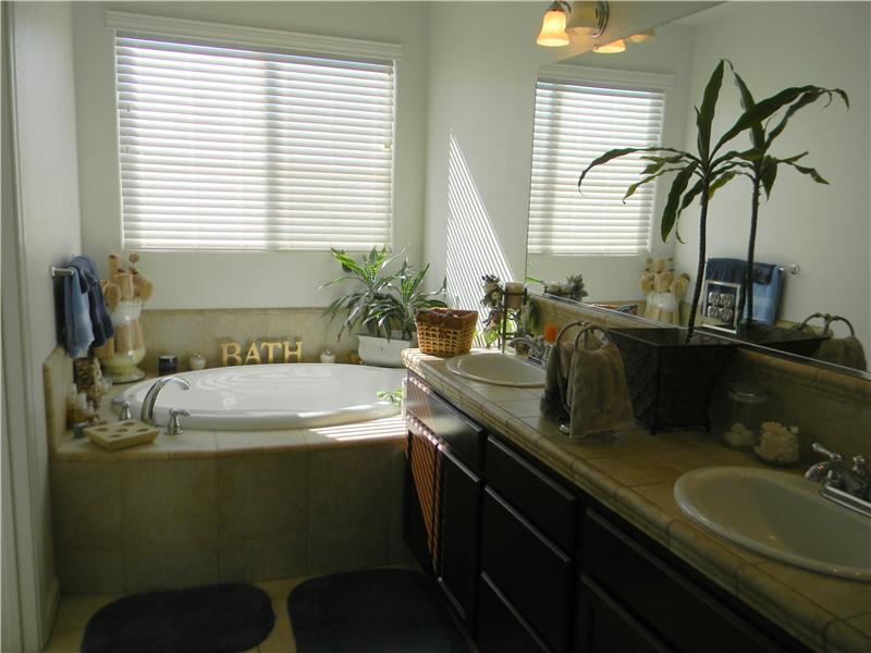 Dual vanities and a soaking tub to enjoy a bubble bath with a glass of wine