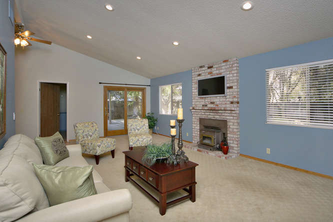 Living room features vaulted ceilings