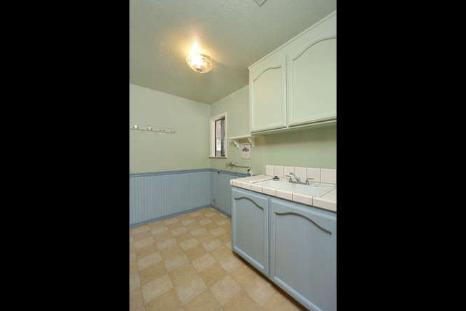 Indoor laundry room with large utility sink