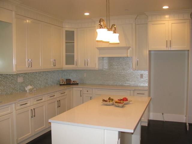 Bright kitchen has quartz counter and plenty of cupboard space