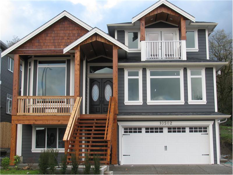 Exterior front showing double garage, sundeck off the Master Bdrm