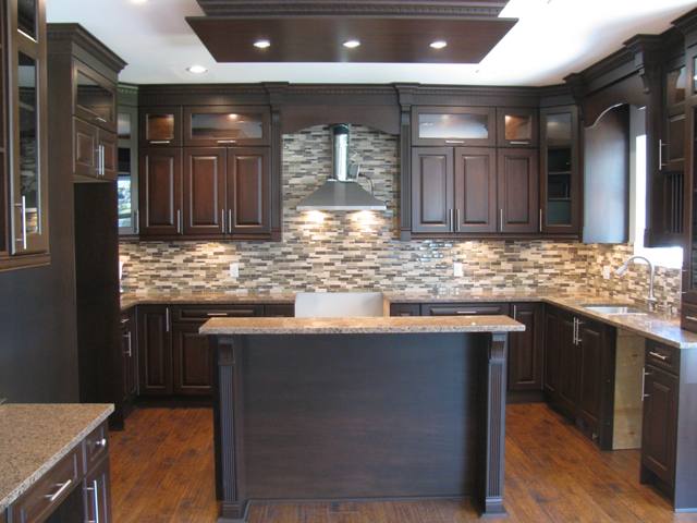 Kitchen with Island, granite counter, interior and under cabinet lights and glass tile back splash