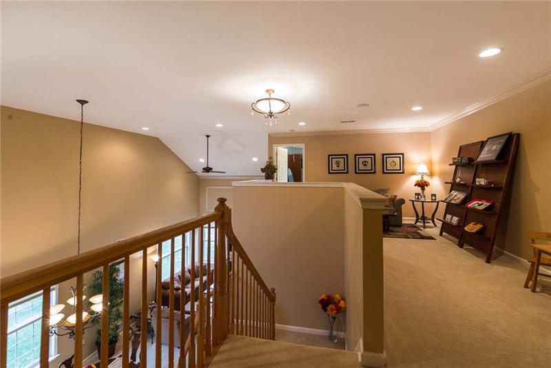 View of stairs from 3rd bedroom. Walls and moldings are painted in neutral colors. Home is move-in ready!