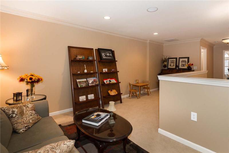 L-shaped loft with wall for privacy. Recessed lights & other design touches throughout the home exude warmth & comfort.