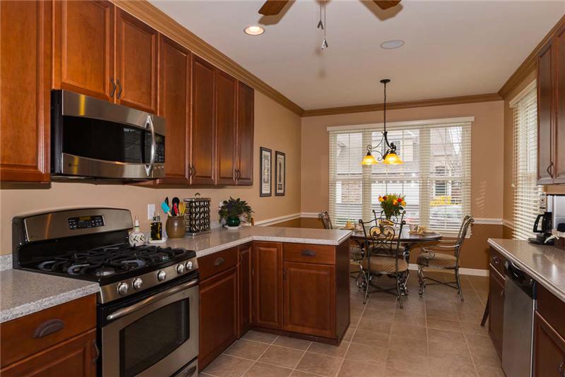 Spacious Eat-in Kitchen with breakfast bar, pantry and ceramic tile floor.