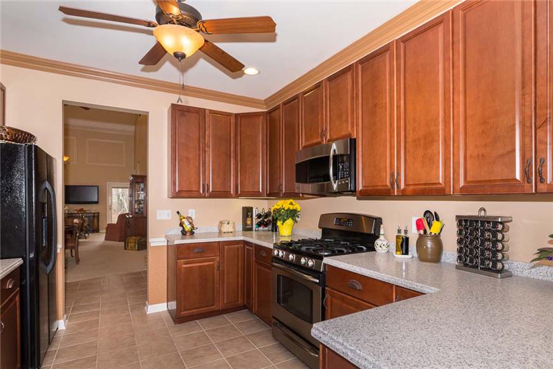 Corian Counters, upgraded appliances, including GE Profile self-cleaning gas range with griddle surface & warming drawer.