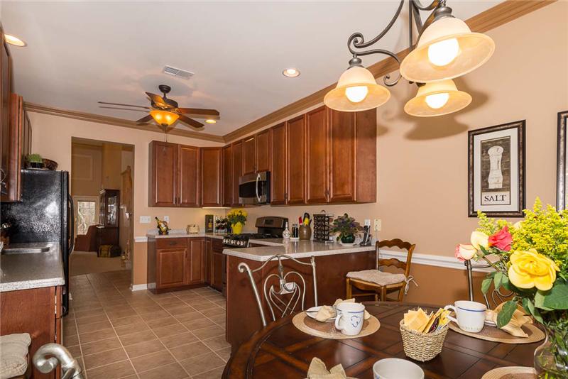 Kitchen with GE side by side black fridge & 2012 GE Profile stainless & black microwave