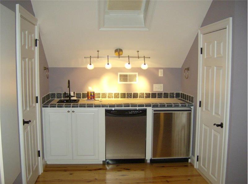 Snack bar with fridge in top floor media/exercise room with half bath too!