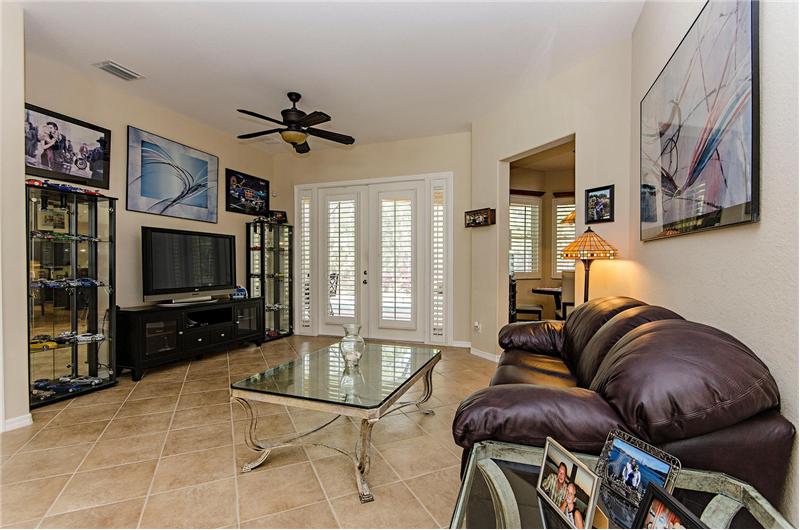 living room with french doors and plantation shutters