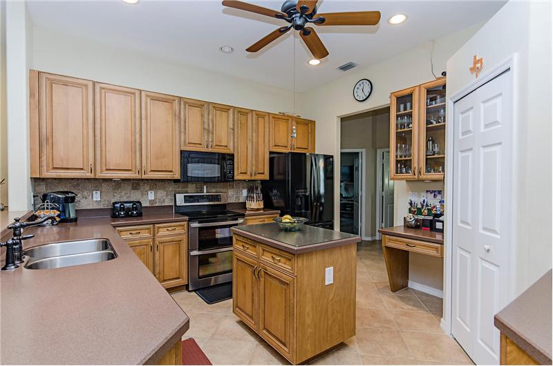 open kitchen with island and breakfast bar