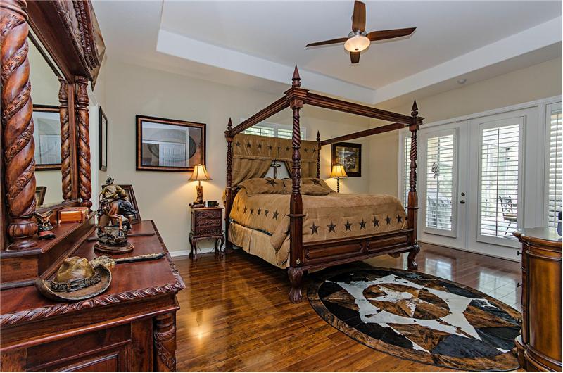 master bedroom with hardwood floors