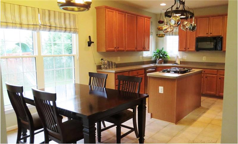 Kitchen has Island with Cooktop and features Double Ovens